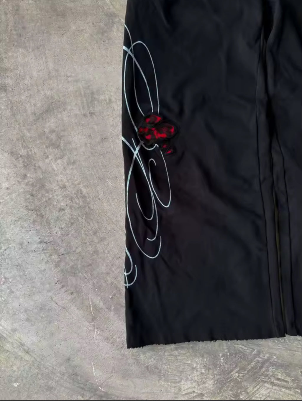Black & red double-waist baggy sweatpants with cursive design