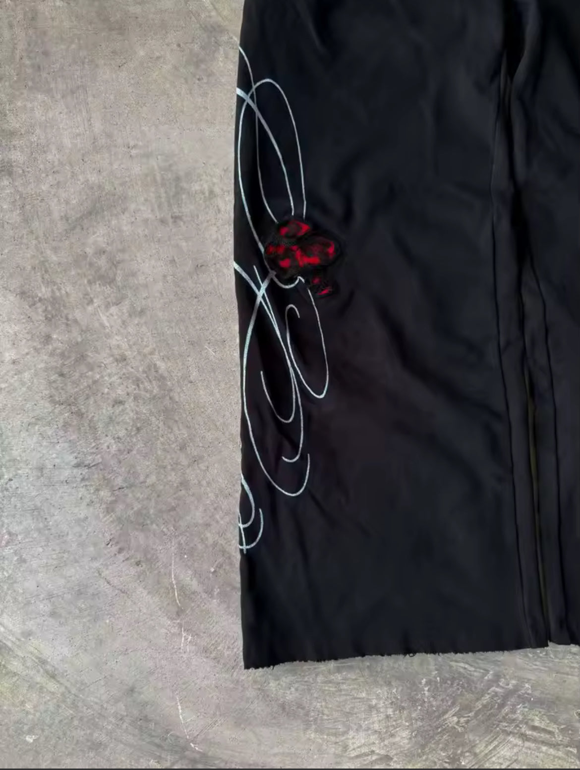Black & red double-waist baggy sweatpants with cursive design