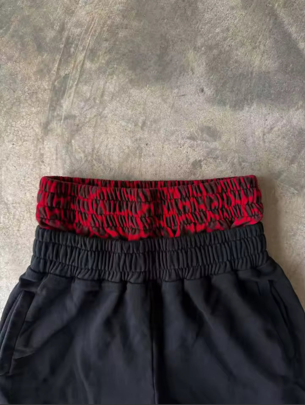 Black & red double-waist baggy sweatpants with cursive design