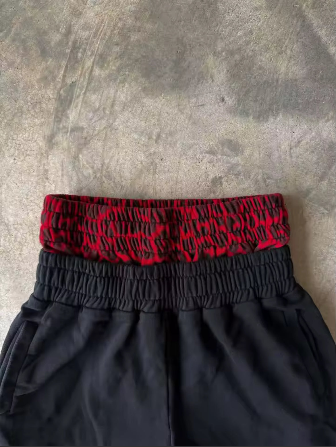 Black & red double-waist baggy sweatpants with cursive design